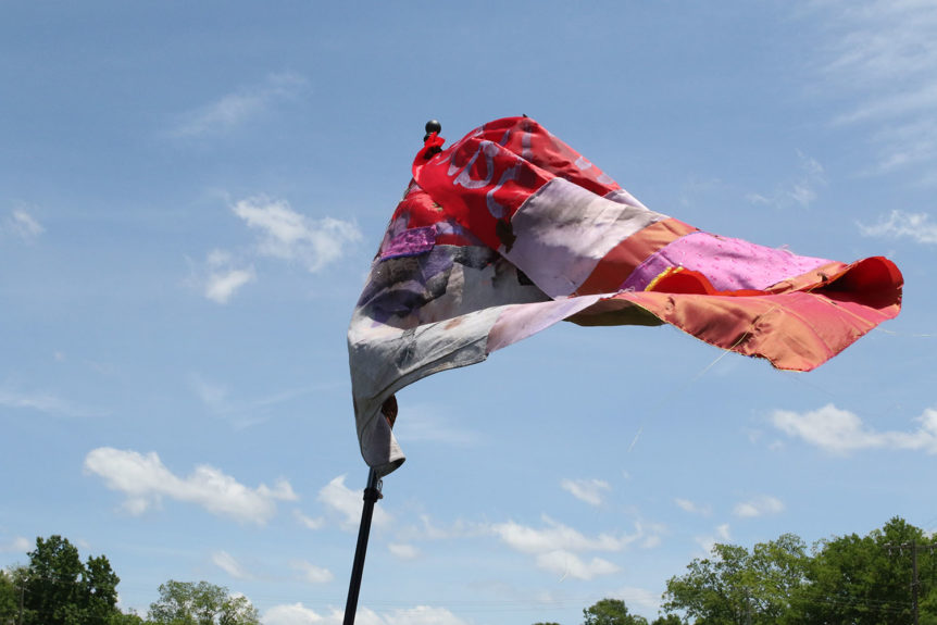 assemblage flag blows in blue sky
