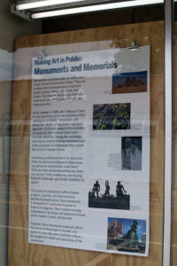 Text panel attached to plain, unfinished plywood behind storefront window